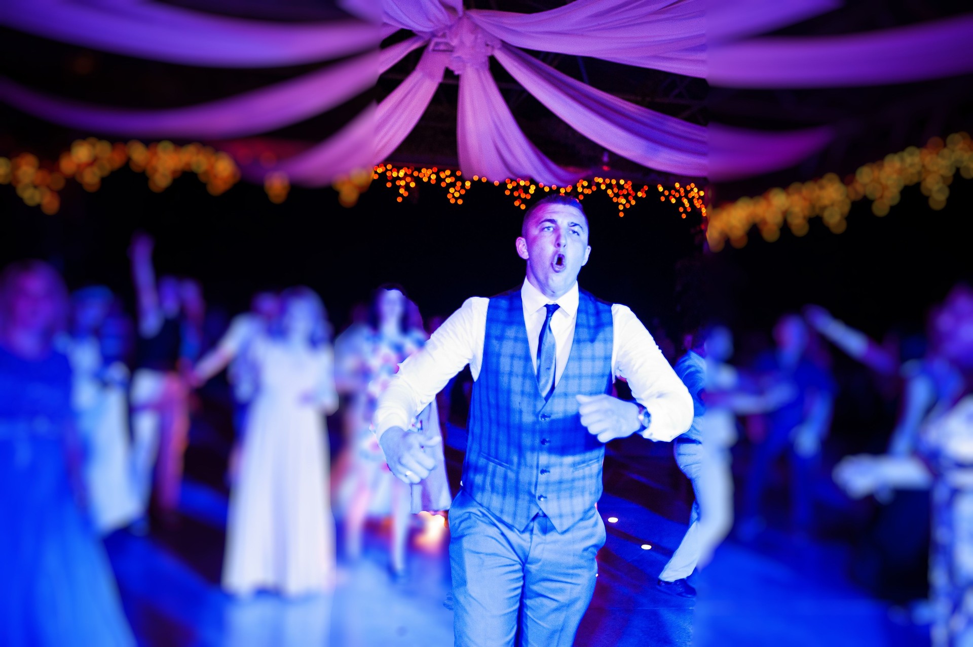 Happy crazy dance of groom at wedding party.